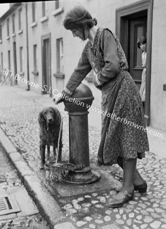 LADY WATERING DOG